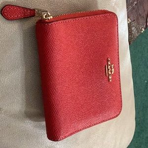COACH leather wallet. Zips all around. Small. Red pebbled leather.